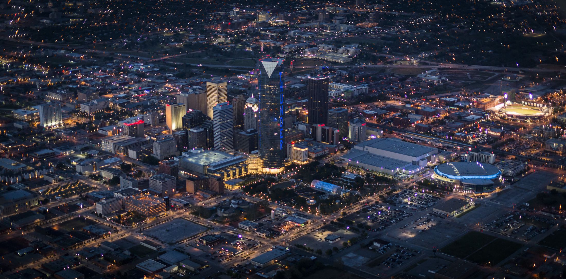 Downtown Oklahoma City at night from the air, Devon Tower lit blue