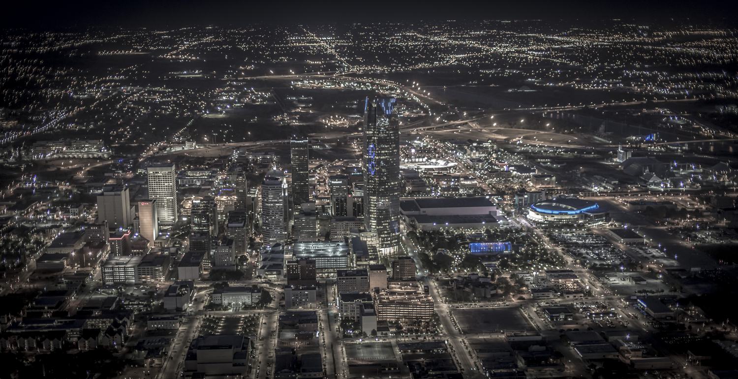 Oklahoma City street grid glowing at night, aerial view